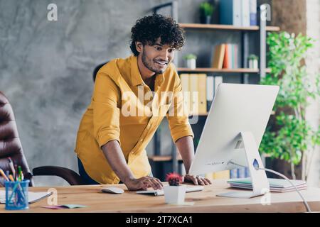 Photo of nice funny man it administrator hacker hacking website modern workstation indoors Stock Photo