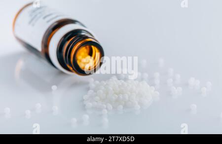 Homeopathic globules in small bottle, homeopathy concept Stock Photo