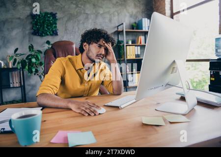 Photo portrait of handsome young guy wear yellow shirt busy overloaded stressed workplace stylish room interior home office design Stock Photo