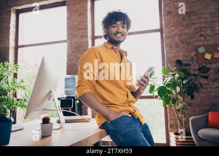 Photo of glad handsome man programmer expert working in modern interior room workspace Stock Photo