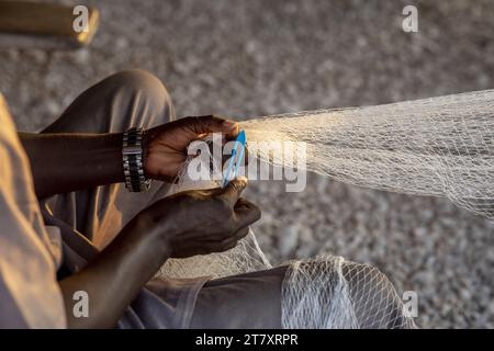 Fisherman mending nets in Fadiouth, Senegal, West Africa, Africa Stock Photo