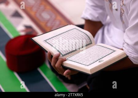 Muslim man reading a Quran, Ho Chi Minh City, Vietnam, Indochina, Southeast Asia, Asia Stock Photo