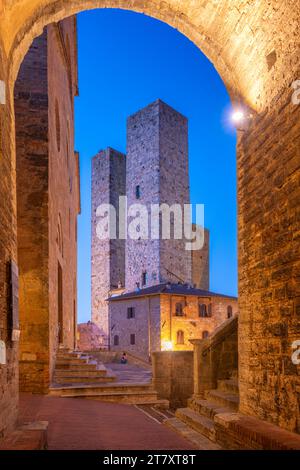 View of towers in Piazza del Duomo at dusk, San Gimignano, UNESCO World Heritage Site, Province of Siena, Tuscany, Italy, Europe Stock Photo