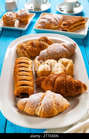 Italian breakfast with pastries, croissant, puff pastry (sfoglia) with chocolate, puff pastry (sfoglia) with cream, rice puddings and espresso Stock Photo