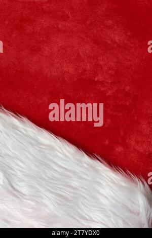 abstract of warm red and white fluffy fabric surface, christmas background or backdrop for card or advertising poster, copy space for text in vertical Stock Photo