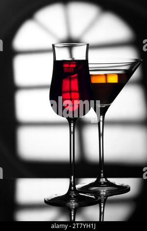 Glass of wine on a black and white background. Glass with a drink on a black and white abstract background. Stock Photo