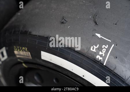 Pirelli’s engineers scrape down the tyres, marking each one by driver number and location of the tyre (front, rear, left or right) and collect data about the wear of the tyre that they then share with that team and the FIA, Mexican City Grand Prix, Mexico, 27 October 2023.  Each team is allocated one Pirelli engineer who can make suggestions based on the wear of the tyres.  Pirelli had one female track engineer at the Mexico City race, Mrs Monica Cuadrado, allocated to the Alpha Tauri team.    After the race in Qatar, the team noticed significant wear on one of the wheels, caused by pyramid cu Stock Photo