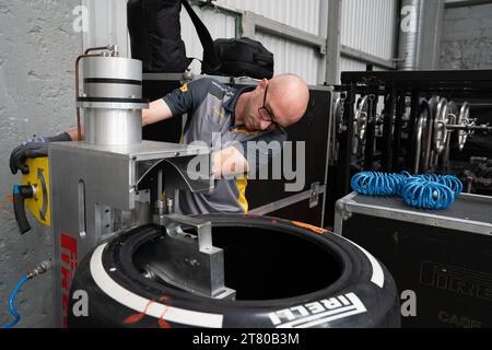 Pirelli’s engineers scrape down the tyres, marking each one by driver number and location of the tyre (front, rear, left or right) and collect data about the wear of the tyre that they then share with that team and the FIA, Mexican City Grand Prix, Mexico, 28 October 2023.  Each team is allocated one Pirelli engineer who can make suggestions based on the wear of the tyres.  Pirelli had one female track engineer at the Mexico City race, Mrs Monica Cuadrado, allocated to the Alpha Tauri team.    After the race in Qatar, the team noticed significant wear on one of the wheels, caused by pyramid cu Stock Photo