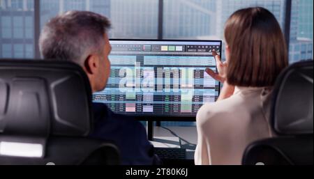 Working Analyst at Desktop Computer with Spreadsheets Stock Photo