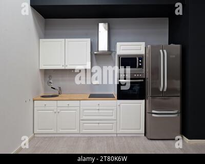 Interior Of Modern White Clean Kitchen With Microwave Oven And Refrigerator Stock Photo