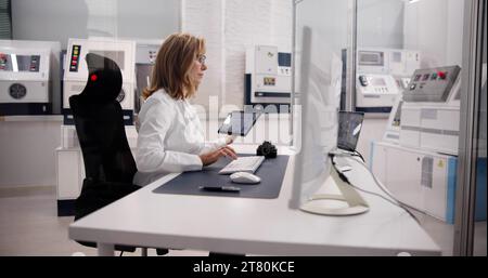 Medical Engineer Using Tablet in Manufacturing Industry Stock Photo