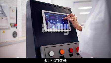 Skilled Operator Repairing Machine in Factory, Boosting Production Stock Photo