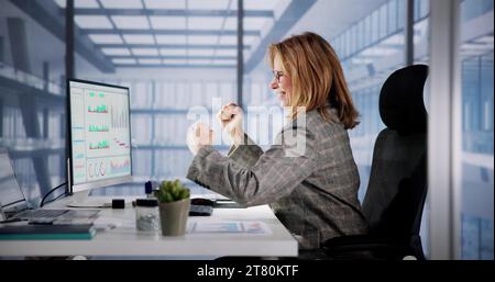 Excited Business Analyst Using Computer Data for Finance Stock Photo