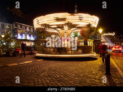 Rotating carousel with illumination in the evening, France Stock Photo