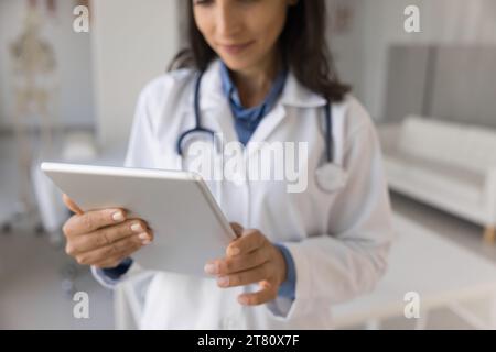 Cropped shot of young practitioner woman using digital tablet Stock Photo
