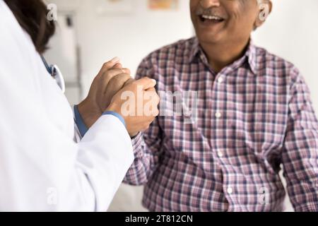 Positive cheerful elder man visiting doctor, consulting therapist Stock Photo