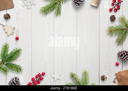 Top view of festive white wooden desk with Christmas decorations, gifts, and copy space. Elegant holiday composition Stock Photo