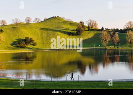 Munich, Germany - April 05, 2023: Olympiaberg und Olympiasee with unidentified people in the Olympic Park in Munich. The Olympic Park was constructed Stock Photo