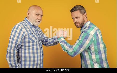 two contradiction of generation in studio. contradiction of two generation on background. image of contradiction of two generation men. contradiction Stock Photo