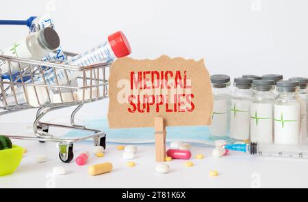 Text Medical Supplies on the white card with the stethoscope and medical documents. Medical concept photo. Stock Photo