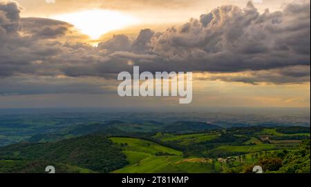 Sun between the clouds, at dusk at Pico do Gavião. Andradas. Brazil Stock Photo