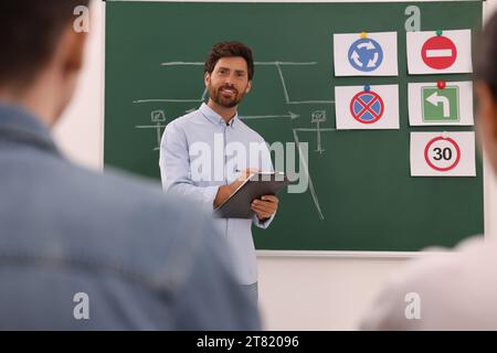 Teacher giving lesson to audience in driving school Stock Photo