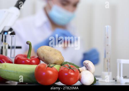 Fresh vegetables on table in laboratory. Food quality control Stock Photo