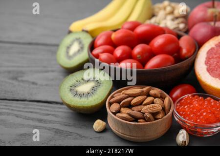 Many different products on grey wooden table, space for text. Natural sources of serotonin Stock Photo