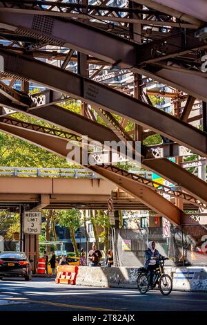 People walking under the Brooklyn Bridge in Manhattan, New York City Stock Photo