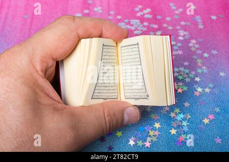 Islamic Holy Book Quran mini size decorated with stars Stock Photo