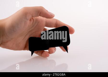 Hand holding dialogue boxes on a white background Stock Photo