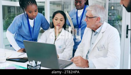Doctors, nurses and laptop for meeting, medical teamwork and solution in hospital or clinic management. Senior expert, healthcare people or group for Stock Photo