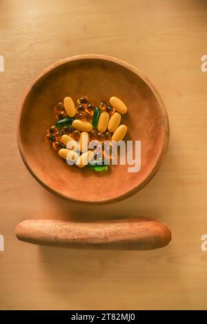 Vitamins and Medicine Tablets and Capsule on a Clay Plate with the Knead Tool Stock Photo