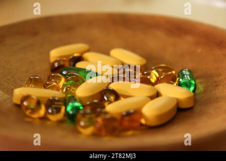 Vitamins and Medicine Tablets and Capsule on a Clay Plate with the Knead Tool Stock Photo