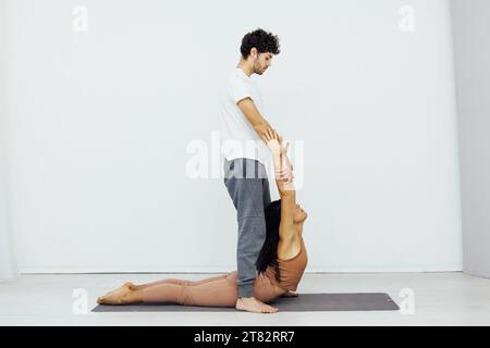 healthy back asana exercises woman and man practice yoga lotus pose stretching Stock Photo