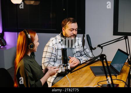 Radio presenters communicate during the broadcast of the evening show ...