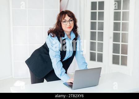 woman in office with laptop internet conversation online communication communication business finance work Stock Photo