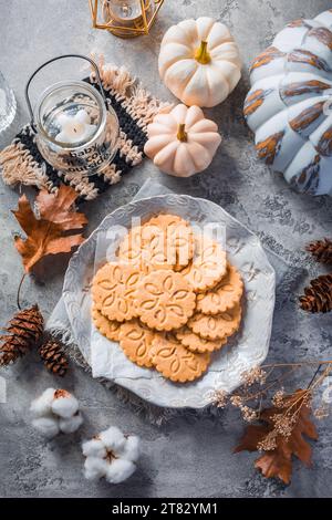 Chai latte cookies or ginger biscuits with pumpkins and candles for autumn season Stock Photo