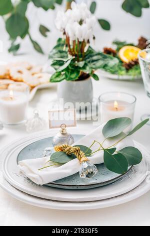 Festive Christmas setting, home table decoration in white and green Stock Photo