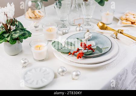 Festive Christmas setting, home table decoration in white and green Stock Photo