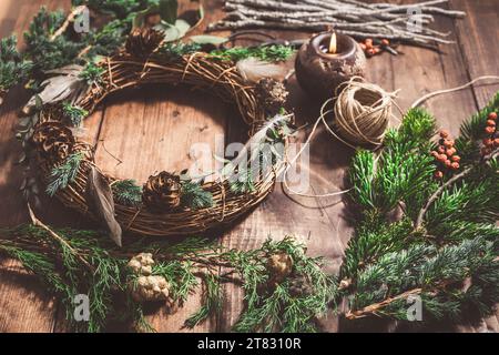 Top down view of florist's worktable. Making of  festive wreath for autumn or Christmas Stock Photo