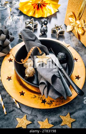 Place setting in golden and black tone for Christmas, New Year Stock Photo