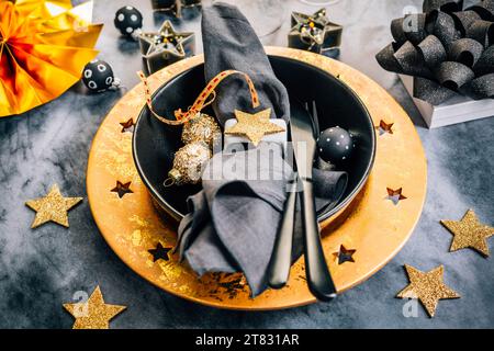 Place setting in golden and black tone for Christmas, New Year Stock Photo