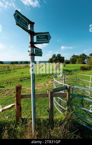 Walking trails and public bridleways show directions on a signpost in the rural English Countryside Stock Photo