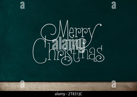 merry Christmas, vintage handwriting on green Chalkboard. Stock Photo