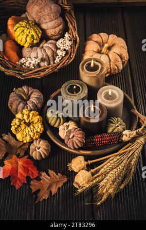 Pumpkins on wooden table - Thanksgiving, fall themed holiday table setting arrangement for a seasonal party Stock Photo