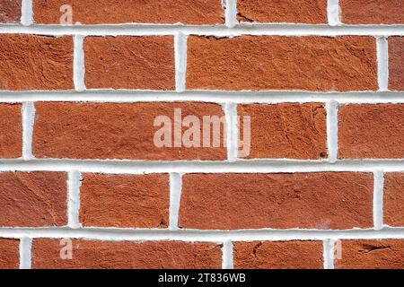Background from a red brick wall with white joints Stock Photo