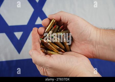 Ammunition from the gun. Bullets . Lend-Lease concept. Army concept. Israeli flag on the background. Stock Photo