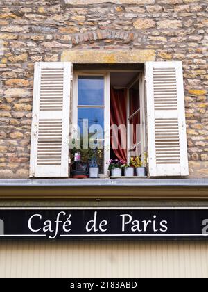 Cluny, France - October 14, 2023: Cafe de Paris - a sign for coffee bar under the open traditional window in Cluny. Stock Photo