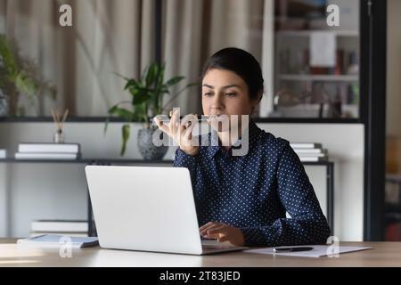 Serious confident Indian business woman, leader working at laptop Stock Photo